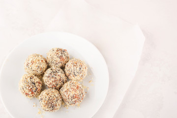 Homemade raw chocolate truffles with nuts and seeds and coconut. Copy space.