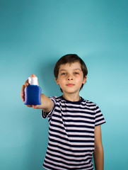 A child on a blue background. Hand antiseptic. Alcohol for hands. Virus and illness protection, hand sanitizer