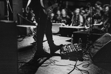 Musician using a pedal board in a concert