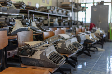 Close up photo of vintage manual typewriter being fixed by a repairman
