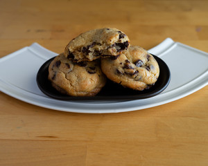 Soft and chewy chocolate chip cookies on a wooden table