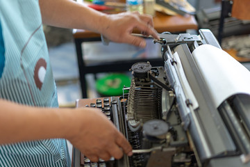 Fototapeta na wymiar Close up photo of vintage manual typewriter being fixed by a repairman 