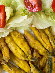 Anchovies battered with flour and fried with lettuce and tomato