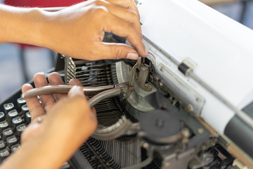 Fototapeta na wymiar Close up photo of vintage manual typewriter being fixed by a repairman 