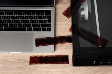 Digitalization process. Negatives on a scanner and a laptop.