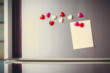 Abstract of wooden heart clip with Blank paper and stick paper on refrigerator door. paper note...
