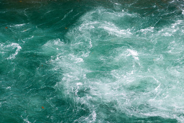 Fototapeta na wymiar Fast flow in mountain river, texture of water