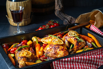 Grilled chicken legs with various vegetables and herbs.