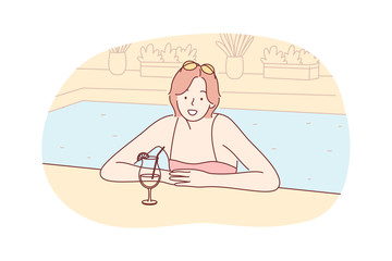 Summer vacation, holiday, rest, tourism, travelling concept. Woman girl tourist on holiday rest at hotel swimming pool with cocktail, looking straight at camera. Summer vacation at sea, ocean resort.