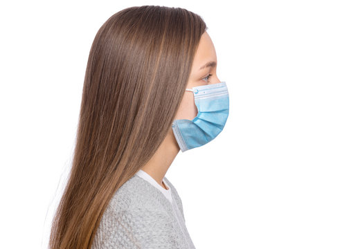 Concept Of Coronavirus Quarantine. Side View, Child Wearing Medical Protective Mask To Health From Influenza Virus, Isolated On White Background. Portrait Of Teen Girl In Protective Face Mask, Profile