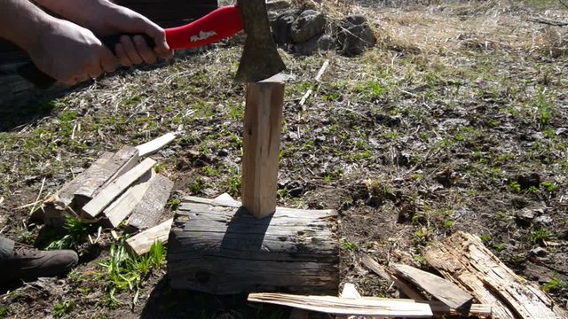 Man chopping wood with an ax. 