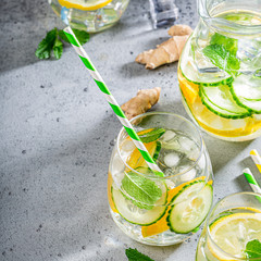 Cold homemade summer healthy diet detox lemonade, cocktails of citrus infused water or mojitos, with lime lemon orange, ice and mint, copy space