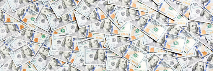 Top view of one hundred dollar banknotes made as a background. USD currency concept. Texture of American dollars