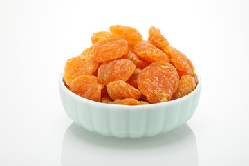 Dried yellow peach fruit on a white background
