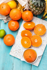 Fresh Orange and Tropical Fruits on Wooden Table. Vibrant Colors Healthy Eating