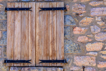 Brown rural wooden shutter closed.