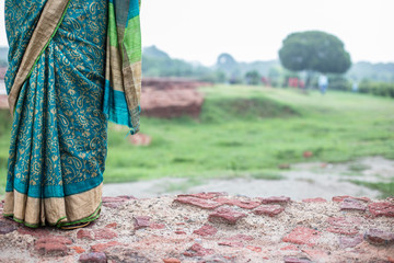 lady with sari in a green field