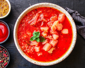 red tomato soup and vegetables and meat, borsch cuisine menu concept keto or paleo diet background. top view. copy space for text