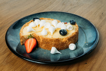 small tart with berries, Bizet on a plate with slices in a cafe