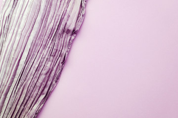 The texture of the background picture the lilac corrugated fabric with parallel or diagonal folds on textured paper.