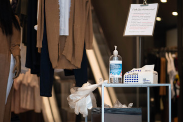 Disinfectant, gloves and tissues at the entrance of a shop during covid or coronavirus lockdown 