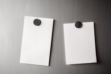 Empty paper sheet on refrigerator door with magnetic clip paper note for add text message.
