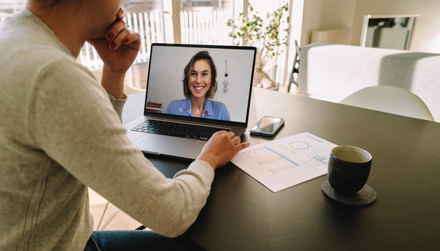Woman teleconferencing with female colleague on laptop