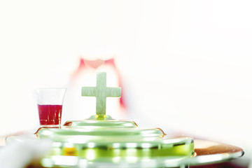 softfocus of cross and red wine communion and easter concept.
