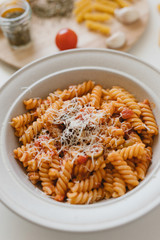 italian homemade pasta with tomato sauce and parmesan