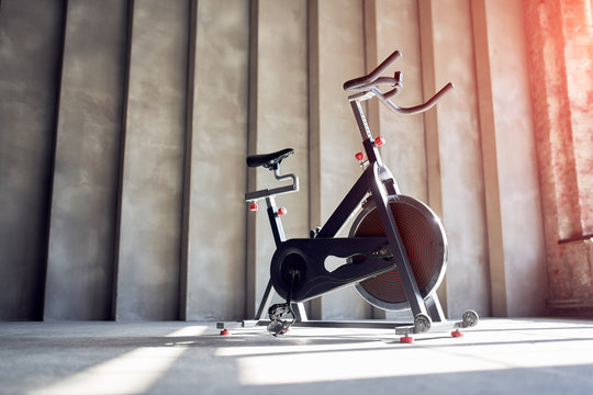 Exercise bike on concrete wall background in gym