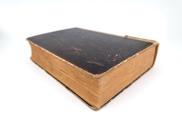 Old shabby and worn book on clean white background