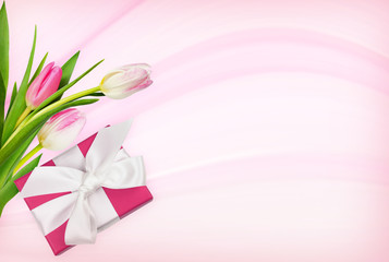 Pink tulip flowers and a gift on abstract holiday background