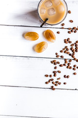 Ice coffee with milk for lunch on white wooden background top view