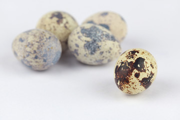 Quail eggs isolated on a white, selective focus