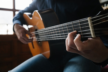 Fototapeta na wymiar hand of man in classical guitar