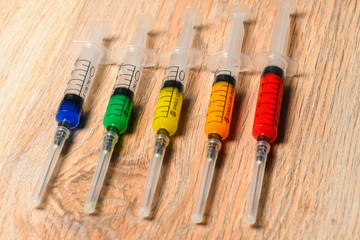 Concept graphics of virus infection from multi-colored syringes. Graphics of the virus epidemic COVID.