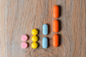 Concept graphics of multi-colored tablets. Graph of the increase in the incidence of viral infection COVID-19.