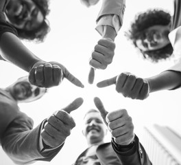Business people giving a thumbs up