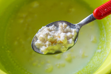 Close up of straining kefir from starter grains. Organic farm milk used for home production of...