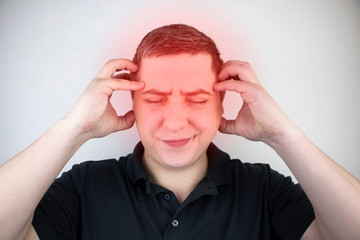 A man holds his head with his hands. Sensation of headache, migraine and dizziness. Headaches from...