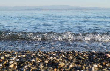 Small waves approaching to the rocky shore of the Marmara Sea. Altinoluk, Balikesir, Turkey.