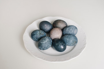Easter blue eggs with cotton on the table