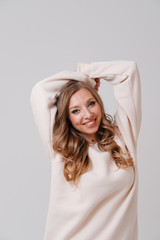 Fototapeta premium Studio portrait of young blonde stretching arms 