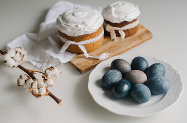 Easter blue eggs and cakes on the table