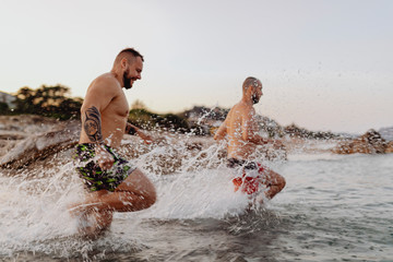 Men running into the water