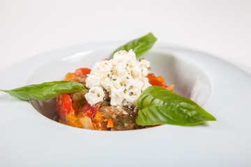 Dishes in white plates on a white background with the application of food design.