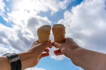 Two ice creams in hands
