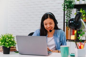 Asian business woman work from home with laptop computer on table with meeting online and video...