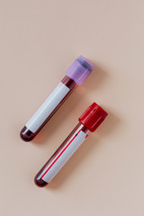 Blood test tubes on a beige background