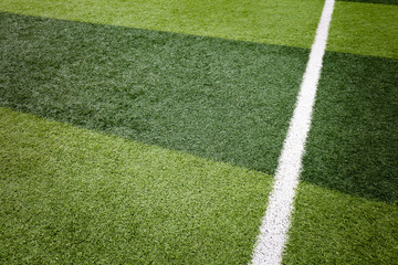 White stripe on the green soccer field from top view